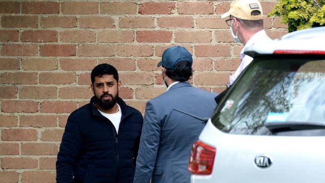 Gemstone dealer Ahmed Luqman Talib, director of Talib & Sons, outside his Melbourne home during a police raid on 20 October. Image credit: Andrew Henshaw/Herald Sun.