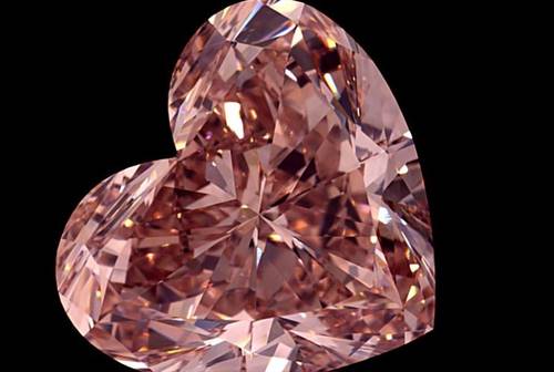 The 15.23-carat fancy intense orangey-pink diamond has been cut in a heart shape, and is one of three stones cut from a 46-carat rough mined at the Lulo sit in Angola.  Image credit: Lucapa Diamond Company