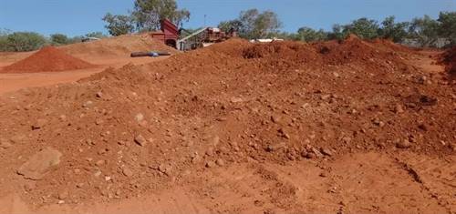 Pre-processing the rain-soaked "A-layer" gravels to dry in the sun. Source: IBDH