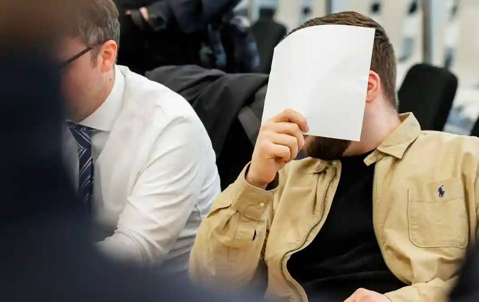 Defendant Rabieh Remmo covers his face as he appears in court. | Image: Reuters