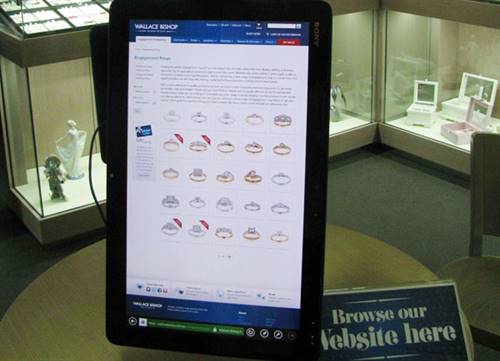 An interactive tablet sits on the counter where customers are encouraged to browse through the website.