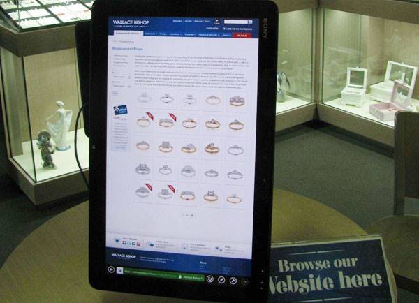 An interactive tablet sits on the counter where customers are encouraged to browse through the website.