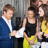 Nico Rosberg signing autographs for guests