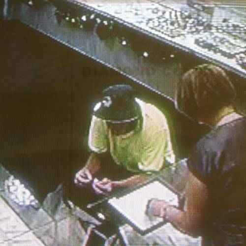 CCTV footage shows Watts dressed as a construction worker with store manager Liljana McDonald. Source: News Limited