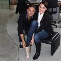 Emma Dimovich trying on the diamond boots with help from husband Tony Andros of Andros Jewellers