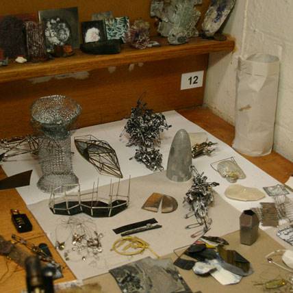 Inari Kiuru's work bench with material samples and developing work.