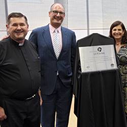 Father Chris Riley with David and Libby Koch - the community centre's namesake