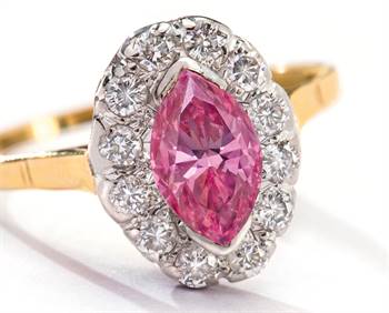 The marquise-shaped pink diamond is set in an 18-carat gold ring, surrounded by brilliant cut diamonds