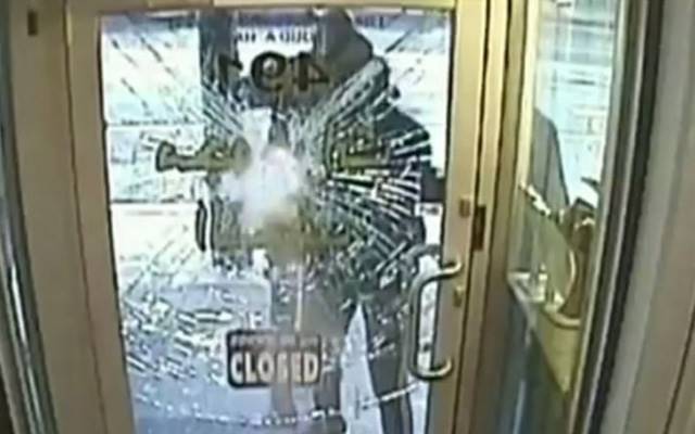 Security footage showing three men attempting to smash the front door of a Sydney Road jewellery store. Source: 7 News